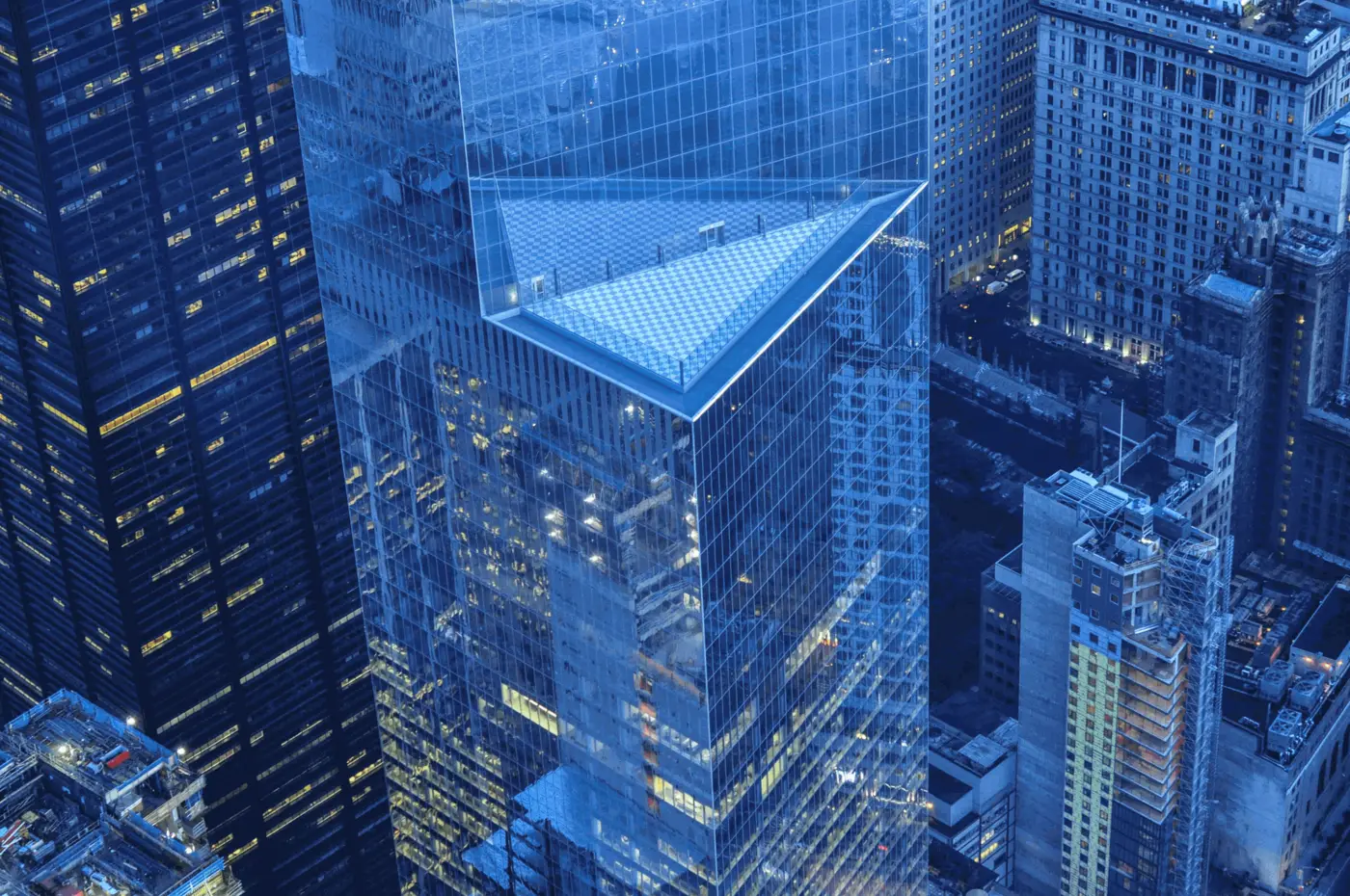 Glass office towers in a financial district at dusk, seen from above